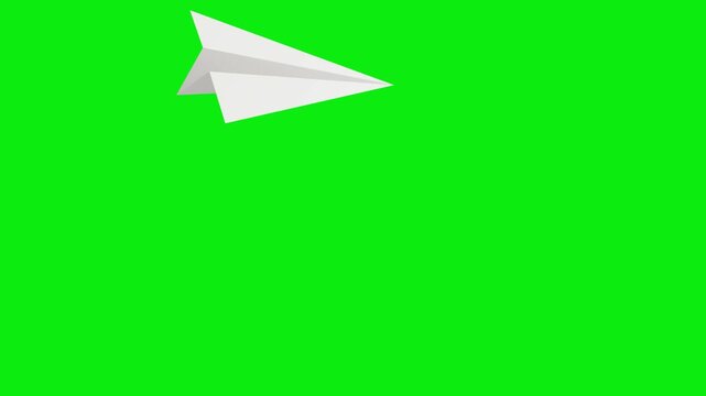 Paper airplane flies over green screen material in mid air