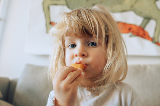 Cute toddler eating snack