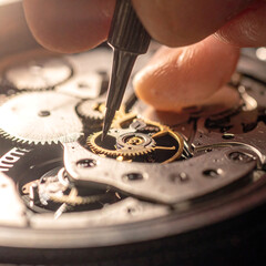 Watchmaker's Precision Fine-tuning a Timepiece's Intricate Gears with a Small Tool