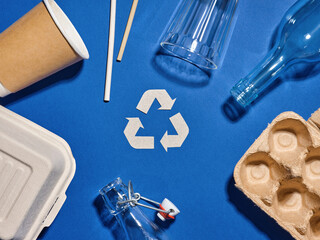 Recycling concept with reusable and recyclable items on blue
