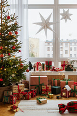 Cozy living room with Christmas decorations, glowing star lights, and festive pillows. Warm holiday atmosphere with gifts and soft lighting.