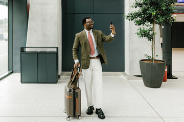 Business Traveler Taking a Selfie in Modern Airport Lobby