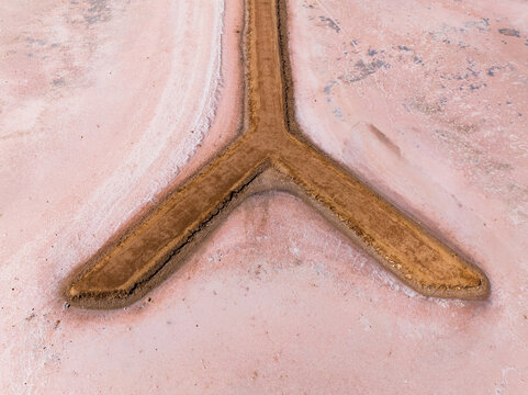 Y sahped walkway out onto a pink salt lake