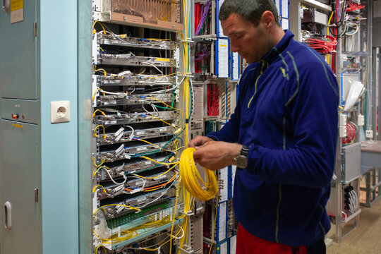 Technician Working on Network Equipment in a Data Center