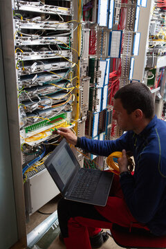 Technician Working on Network Equipment in Data Center