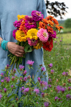 Woman holding zinnia bouquet