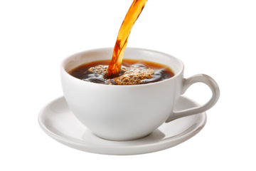 Hot coffee being poured into a white ceramic cup and saucer against a black background