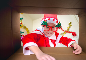 Child in Santa Outfit Sharing Festive Joy Open Present Gift Box, Happy Kid Opening Giftbox in Xmas Tree Home Interior