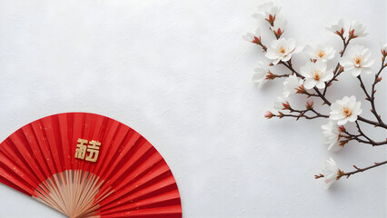 Red fan with Chinese character and cherry blossoms on white background symbolizing fortune, spring, and cultural elegance.