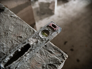 Dirty spirit level on construction site