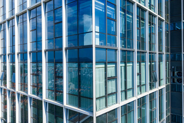 Close up view of modern glass building facade with reflections