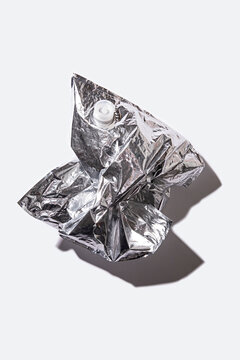 Close-up of a used wine bladder with a white background and a shadow