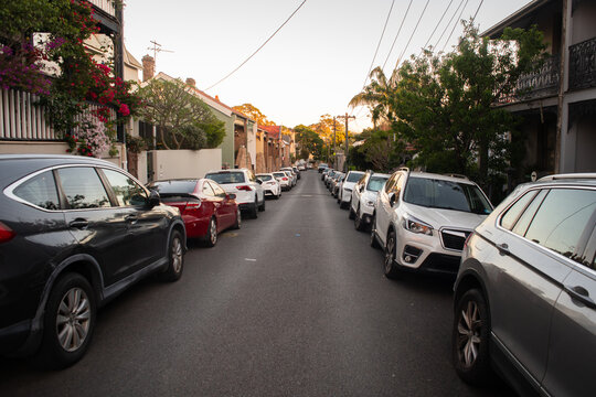 narrow street with cars parked on both sides