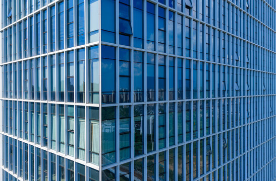 Close up view of modern glass building facade with reflections