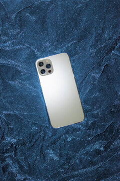 Tech mock up smart mobile phone on shiny glitter background with flash