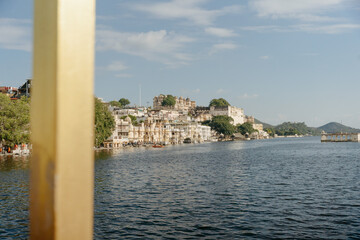 Scenic View of Lakeside Buildings With Mountains in the Distance