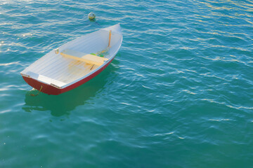A solitary boat moored in clear, calm azure water