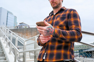 casual man in city using mobile phone