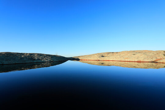 Pool of water on the top of Pildappa Rock. Eyre Peninsula. Australia.