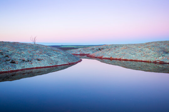 Pool of water on the top of Pildappa Rock. Eyre Peninsula. Australia.