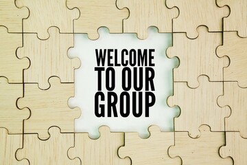 Wooden puzzle with the words welcome to our group. new member concept. HR concept. We're so excited to have you as a part of the team and can't wait to see all the great things you do