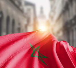 Morocco flag fluttering on blur street with building. Morocco national flag for independence day.
