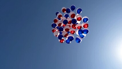 Tricolor balloons rising into clear blue sky
 - Powered by Adobe