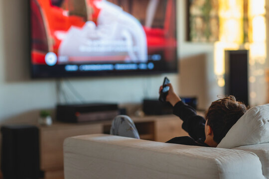 Child enjoying an animated film at home on a cozy evening 
