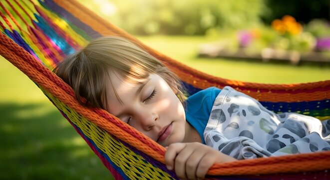 Young child sleeping peacefully in a colorful hammock relaxing outdoors in the backyard on a sunny day enjoying summer vacation