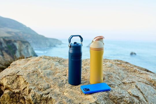 Thermoses set down on the rock in Big Sur