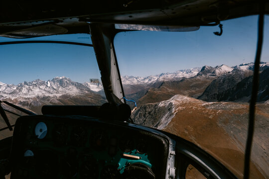 Aerial View of Snowy Mountains from Helicopter Cockpit