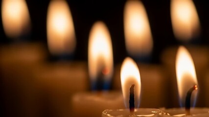 Gentle Candle Flames Dance in Dark with Soft Focus Warm Glow.
