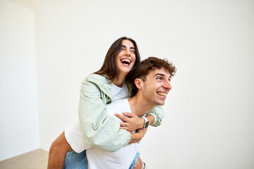 Friends enjoying a playful moment indoors at an art gallery