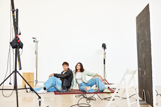 Young adults posing for a photo shoot in a studio setting