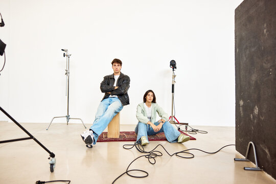 Couple posing for a photoshoot in a minimalist studio setting