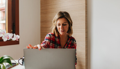 Portrait of woman working from home on laptop