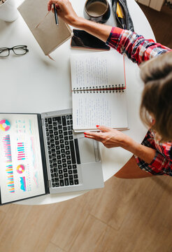 Top view of woman analyzing data and notes