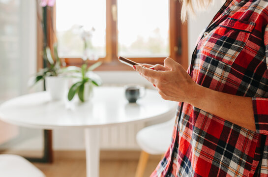 Close-up of woman hands using phone indoors