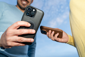 People comparing smartphones outside