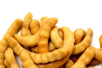 Sweet preserved tamarinds on white background.