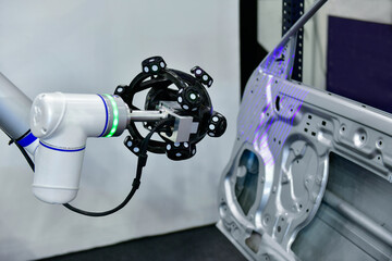 3D scanner on robotic arm measure the accuracy of large automotive parts. in industrial plants