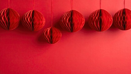 Decorative red honeycomb paper balls suspended against a solid crimson background for celebrations.