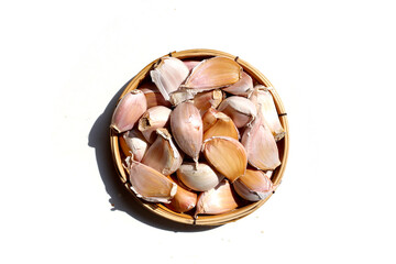 Garlic cloves on a white surface.