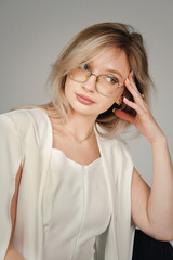 Portrait of a girl in a white suit on a white background. Female portrait.