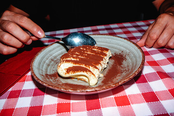 a man about to eat tiramisu in italy