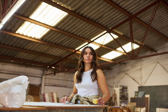 Artist working in a bright warehouse studio with creative energy