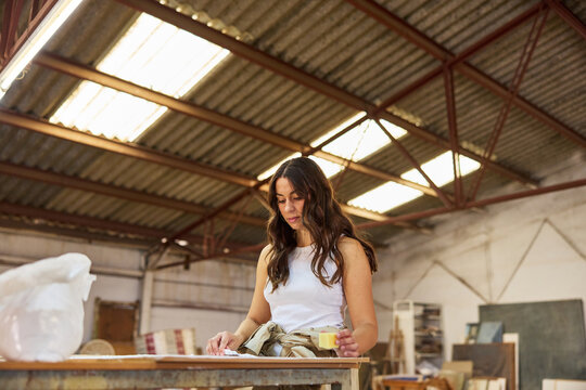 Creative artist working on a project in a spacious workshop