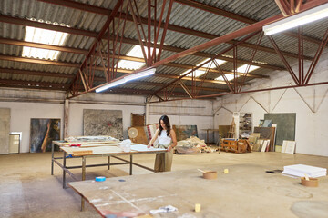 Creative artist working in a spacious studio filled with art sup