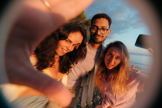 Distorted portrait of three friends looking at camera