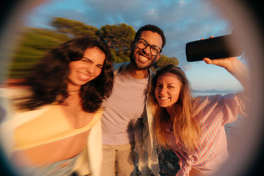 Distorted portrait of three friends looking at camera